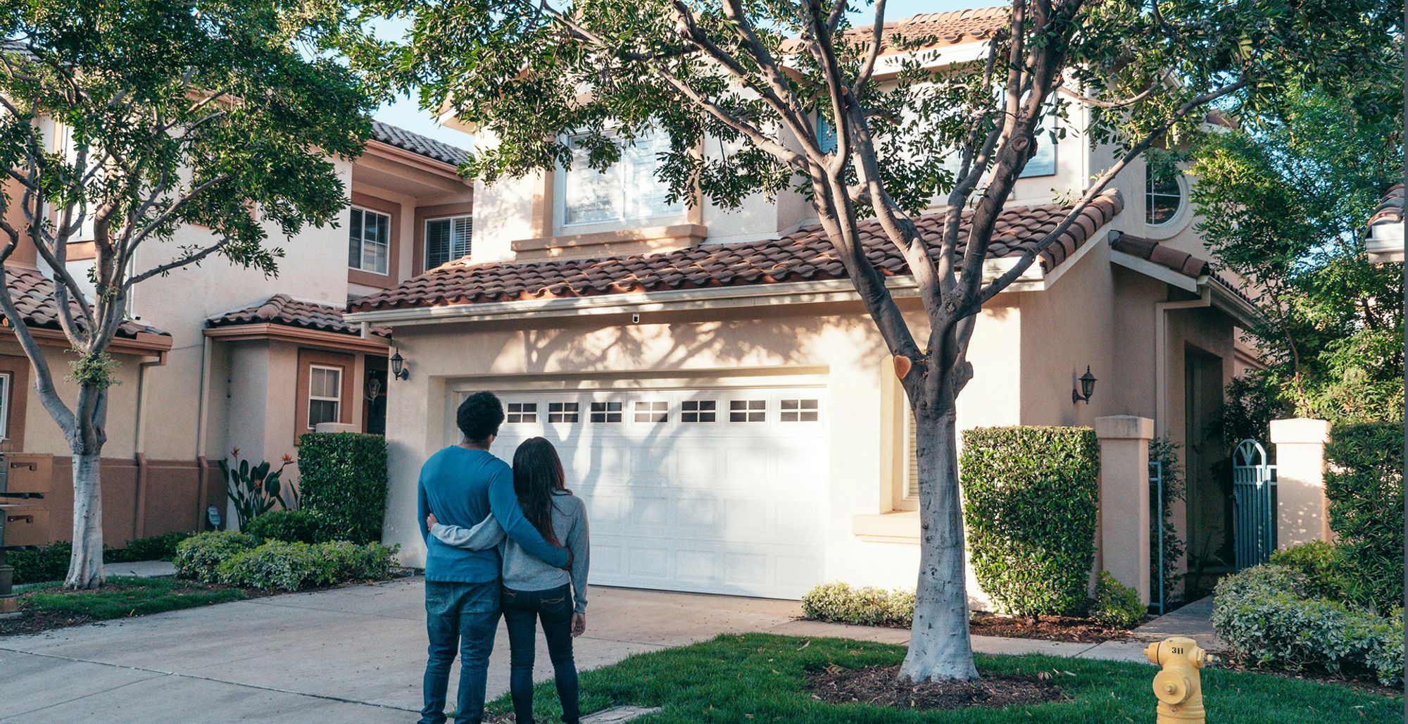 Happy couple admiring their newly painted house